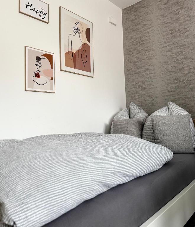 a bedroom with a bed and two pictures on the wall at Solo by Zirwick Apartment in Weiherhammer