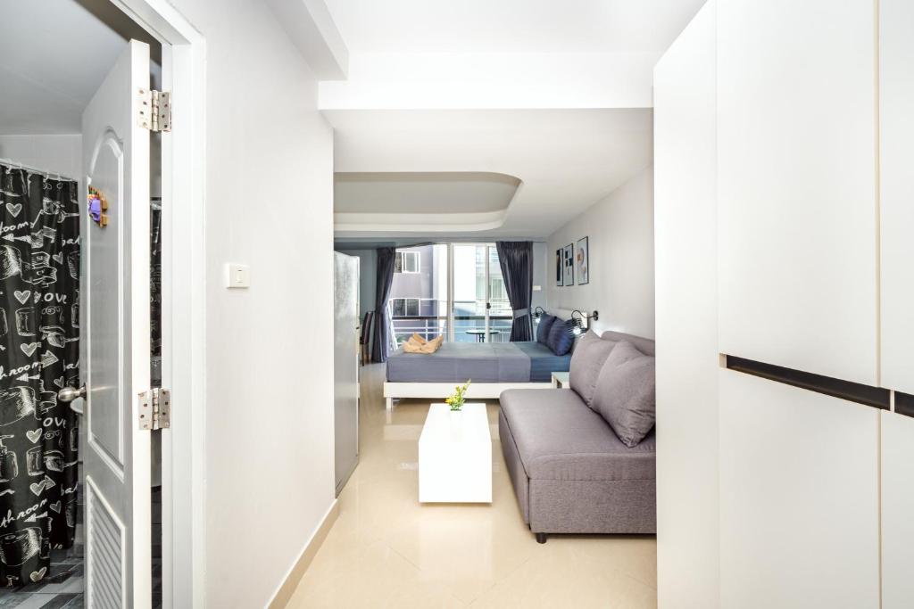 a living room with a couch and a table at Hua Hin Condo A - Maysa & Hin Nam in Hua Hin