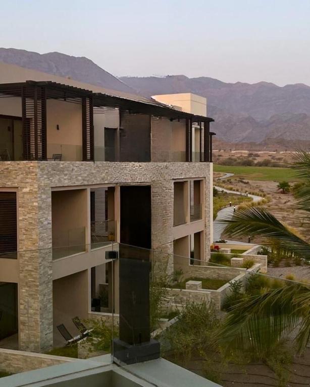 an apartment building with a view of the desert at Sifa Golf & Beach Escape in As Sīfah