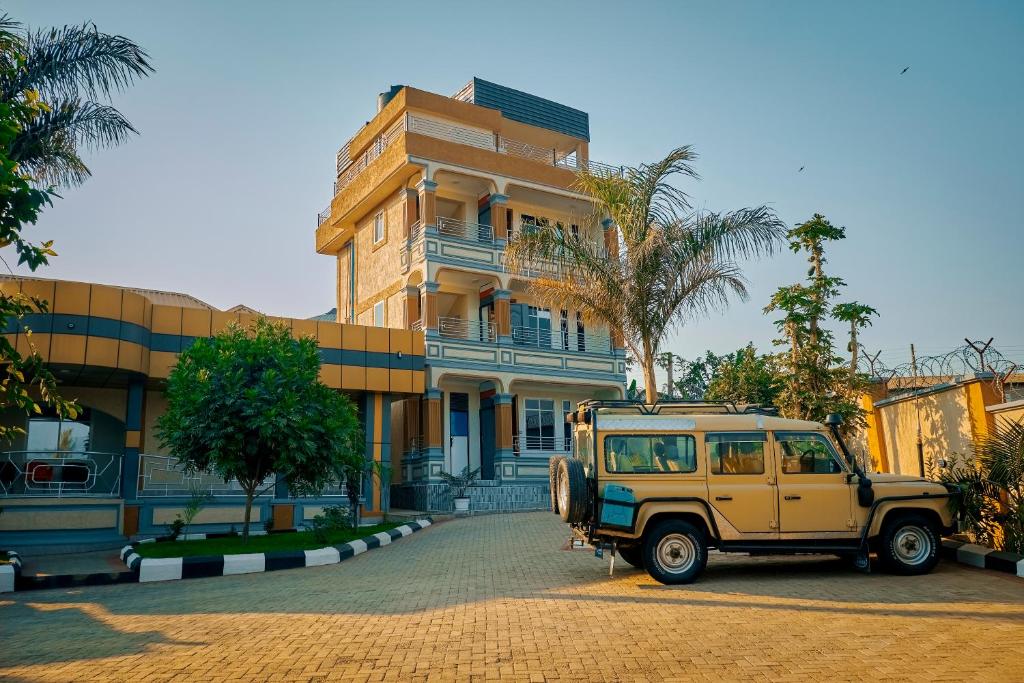a yellow jeep parked in front of a building at Cityscape And Retreat Hotel in Mbeya