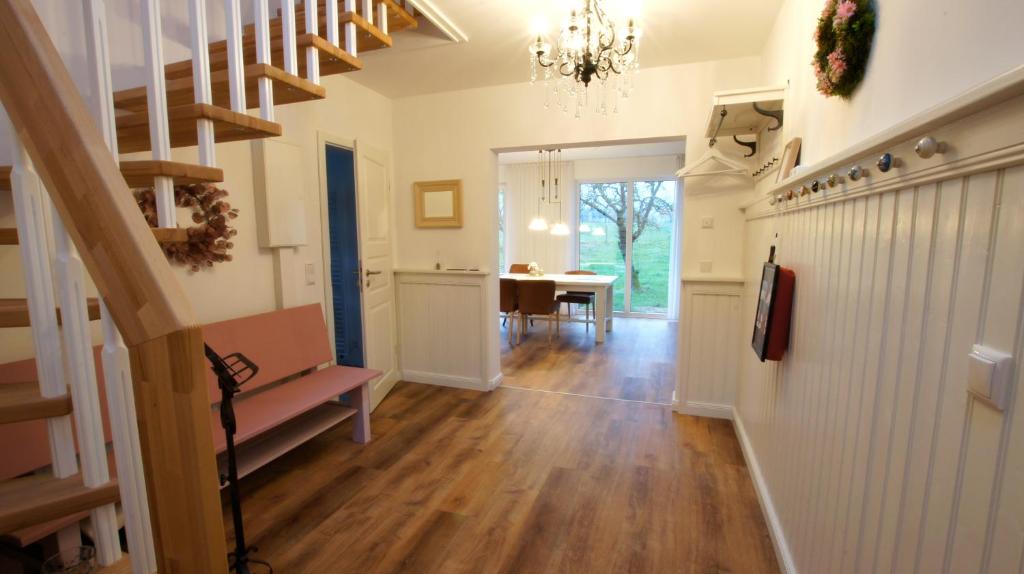 a hallway with a staircase and a dining room at Ferienhaus Sonne in Göhren-Lebbin