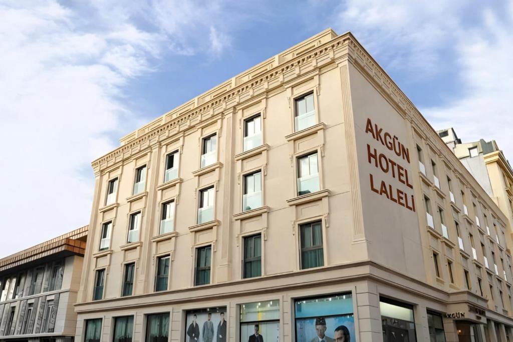a building with a sign on the side of it at Akgün Hotel Laleli Istanbul in Istanbul