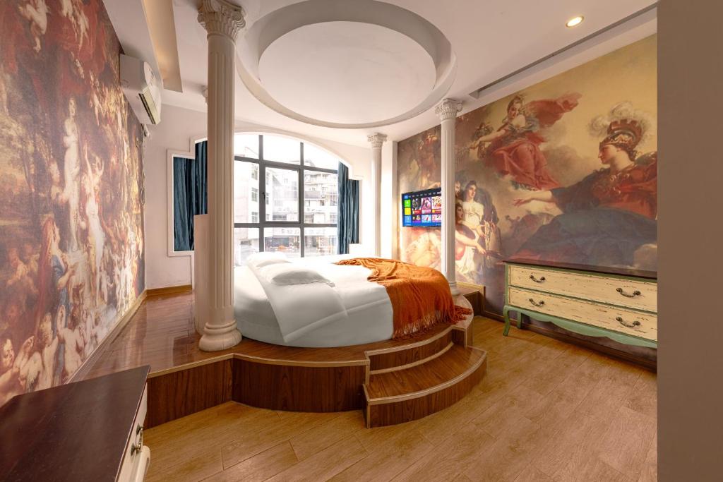 a bedroom with a bed and a painting on the wall at YISHUYIHUACoFFee Hotel in Zhangjiajie