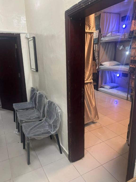 a room with a chair and two bunk beds at OST Homes Rolla Park in Sharjah