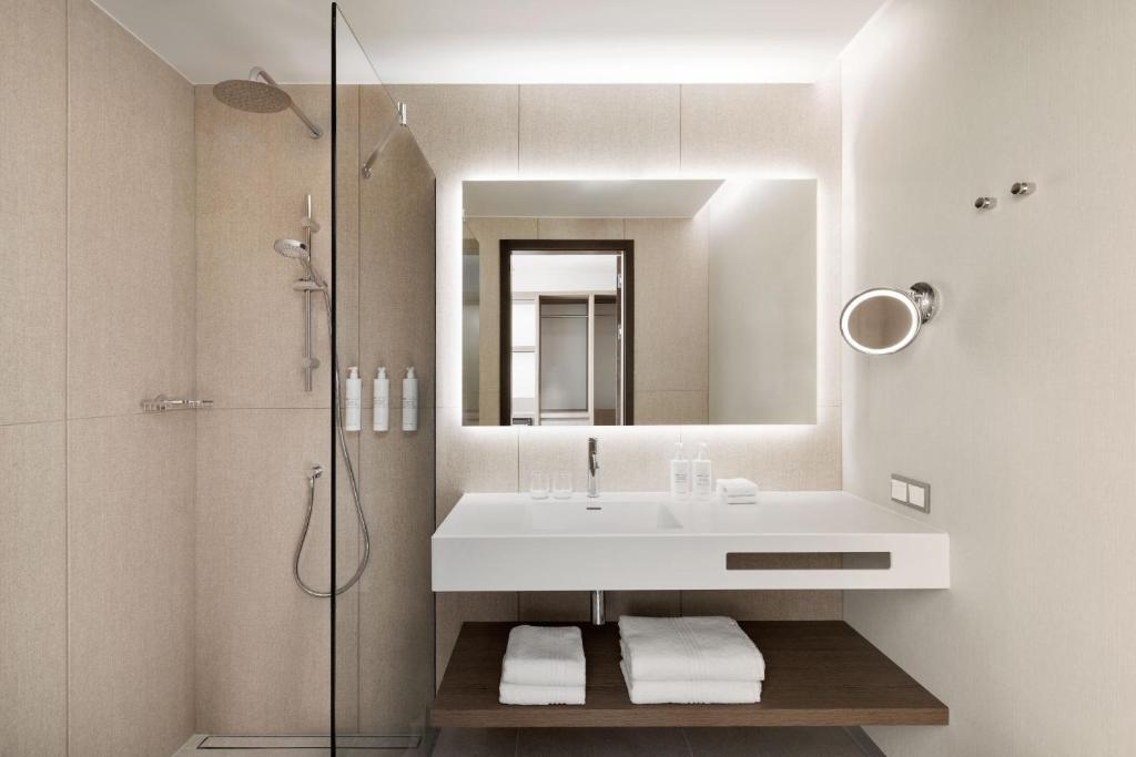 AC Hotel by Marriott Vilnius — A white bathroom with a sink and a mirror