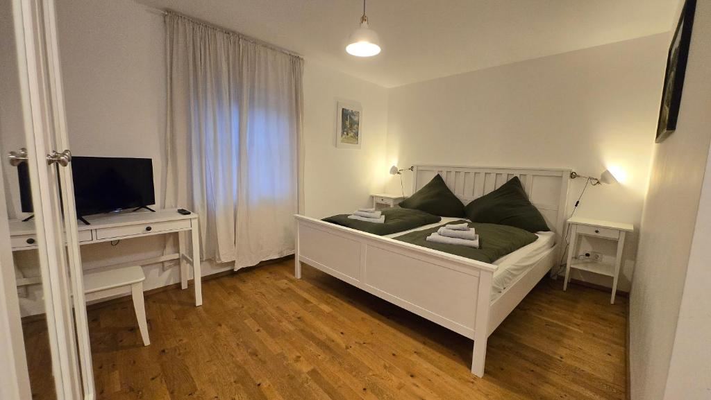 a bedroom with a bed and a desk with a television at Wirt zSeifriedswörth in Wurmsham