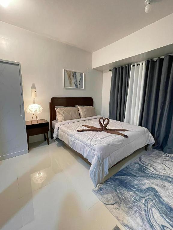 a bedroom with a bed with a ribbon on it at New Cozy Studio Apartment in Cebu City