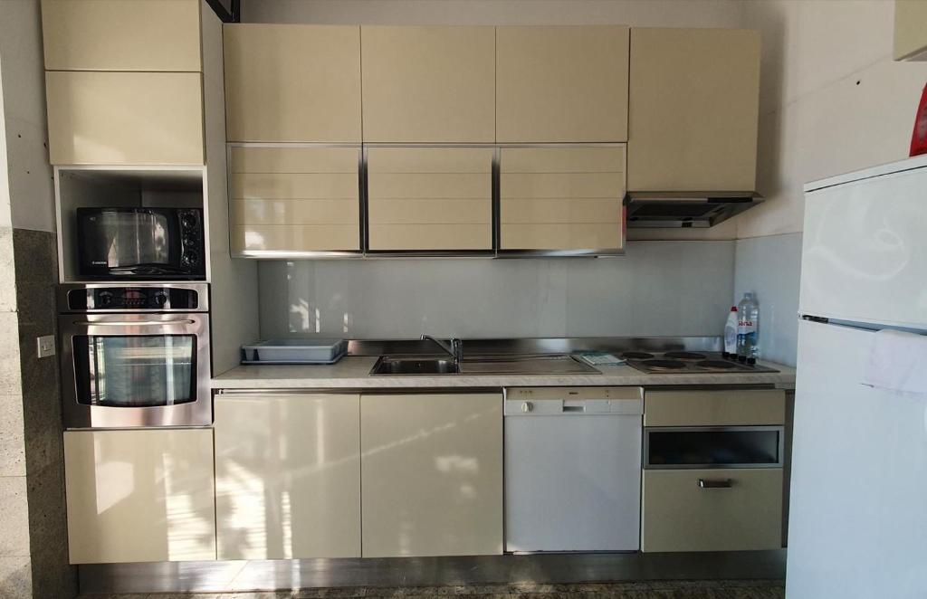 a kitchen with stainless steel appliances and white cabinets at 230 MESTRO in Stanići