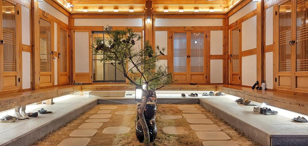 a large bathroom with a tub with a tree in it at 나들한옥 한옥스테이 in Gyeongju