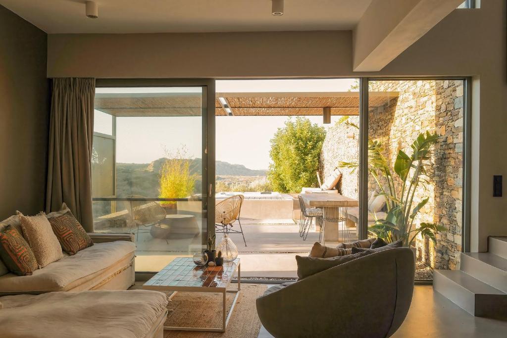 a living room with a couch and a table at Hidden Retreats Kythera in Platia Ammos