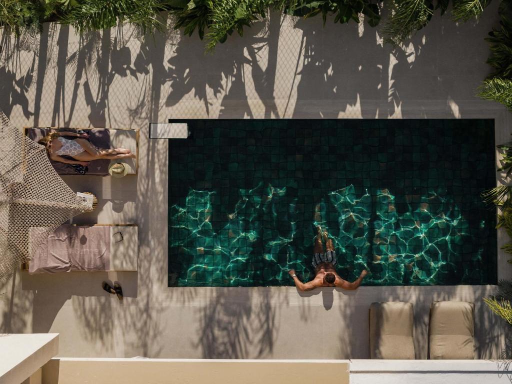 a swimming pool with a diver in the water at Terra Mare Villas in Ialysos