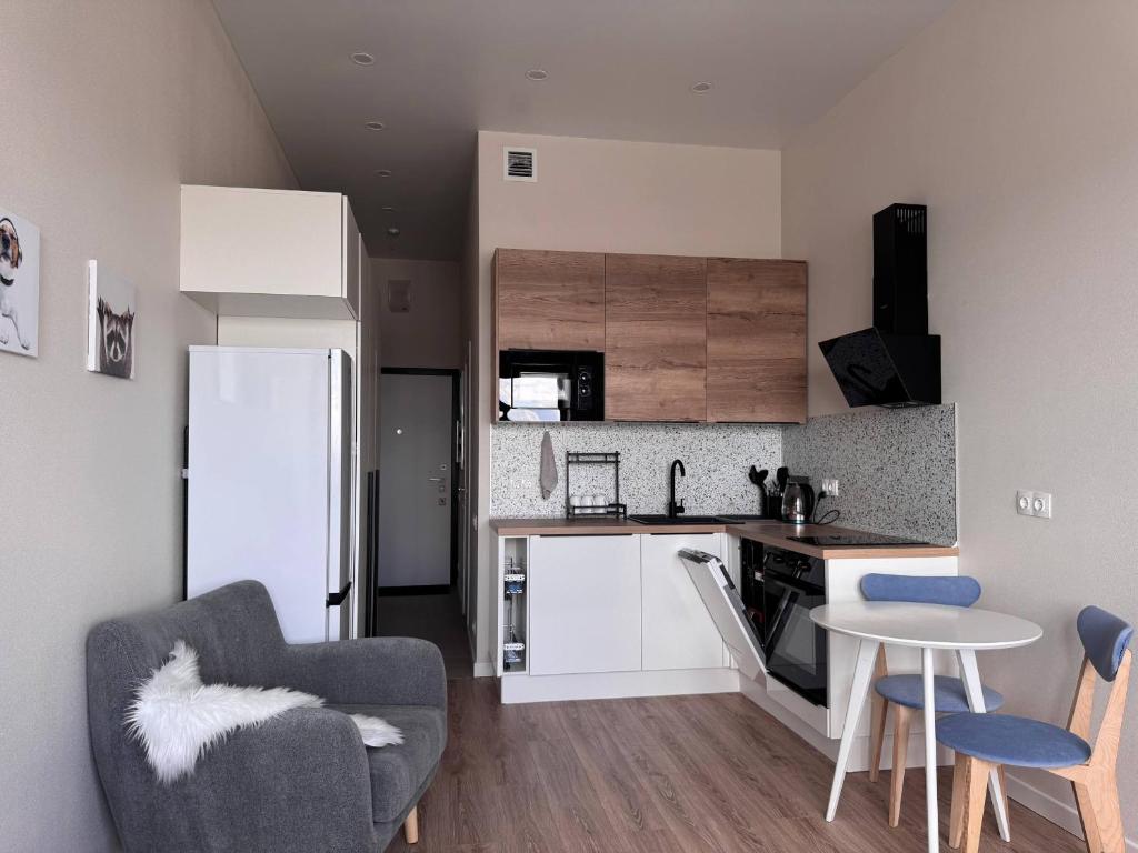 a kitchen with a refrigerator and a table and chairs at comfortable apartment in Vancouver