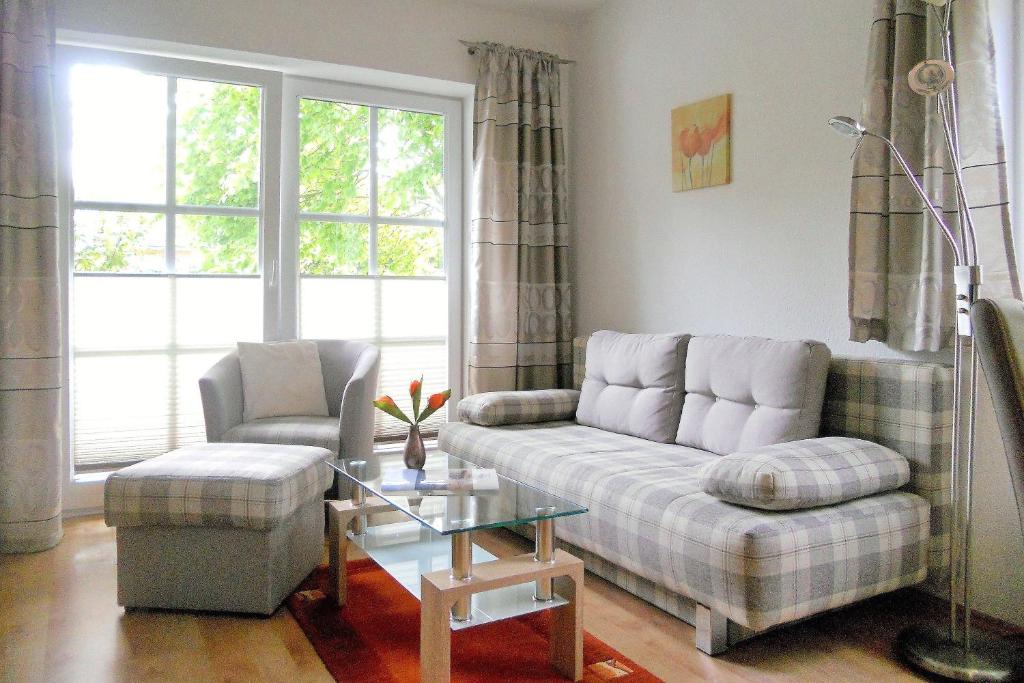 a living room with a couch and a chair and a table at Rugstieg 8 Whg 2 in Wyk auf Föhr