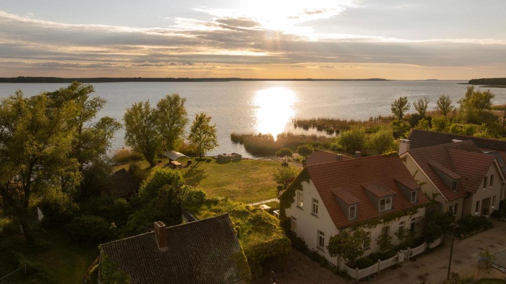 an aerial view of a house next to a body of water at Ferienhaus Peeneblick - exklusives Traumhaus in Direktlage am Wasser mit Bootssteg und Aussensauna in Rankwitz