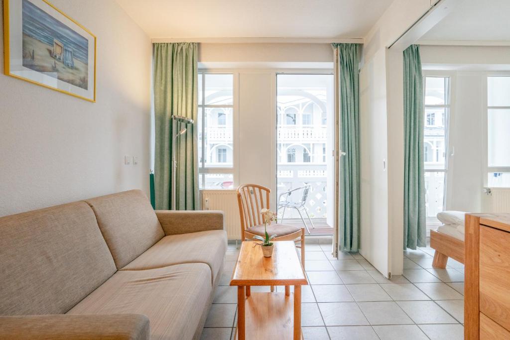 a living room with a couch and a table at Fewo 517, Seepark Sellin in Ostseebad Sellin