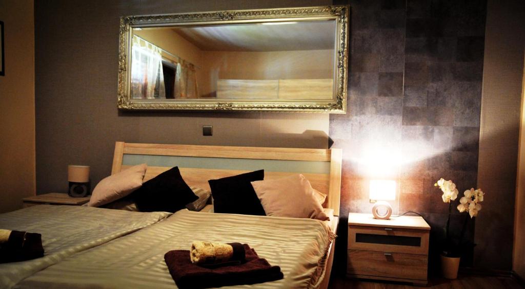 a bedroom with a bed with a mirror on the wall at Apartment Vesna in Supetarska Draga