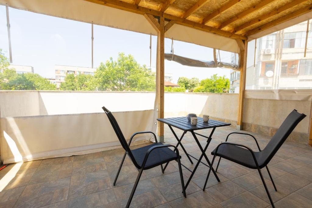 a patio with a table and two chairs at Тракия 3А in Shumen