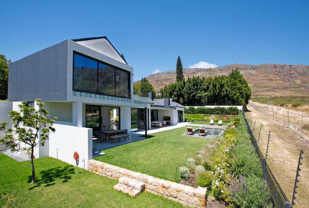 a house with a view of the backyard at Table Mountain Constantiaberg view in Sweet Valley