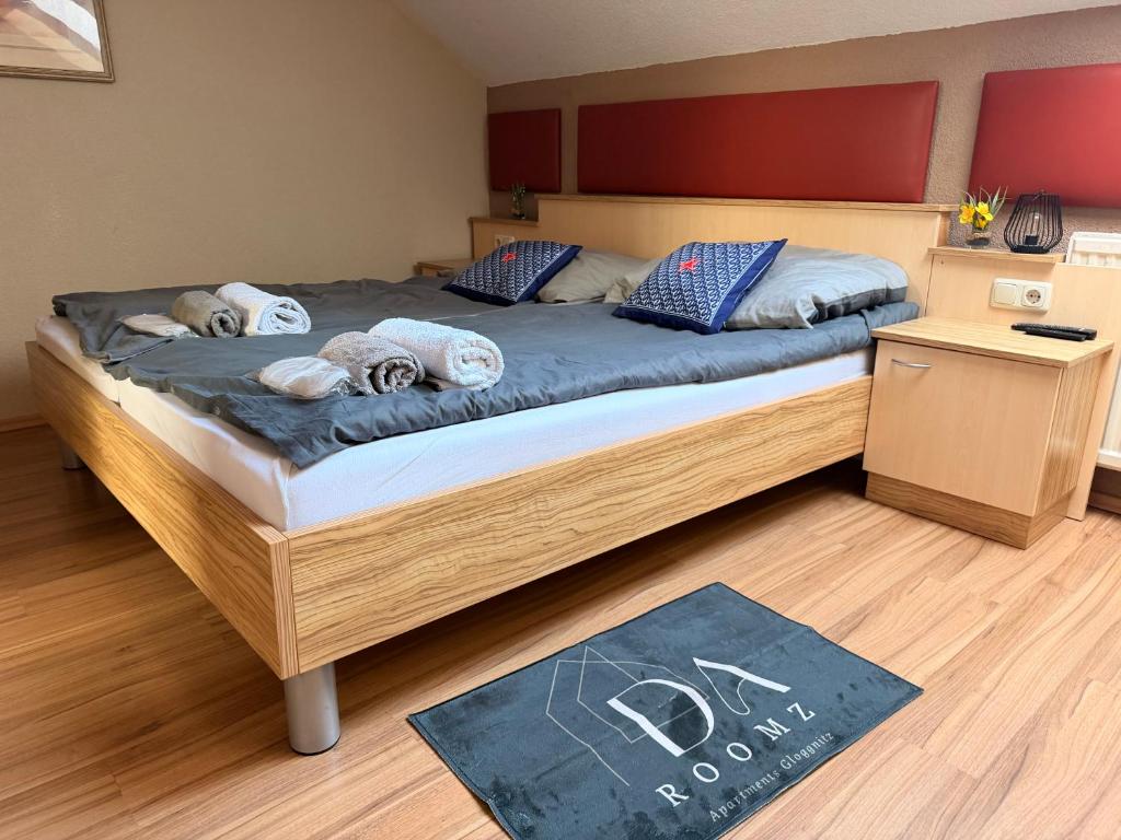 a bedroom with a large bed with towels on it at daroomz in Gloggnitz
