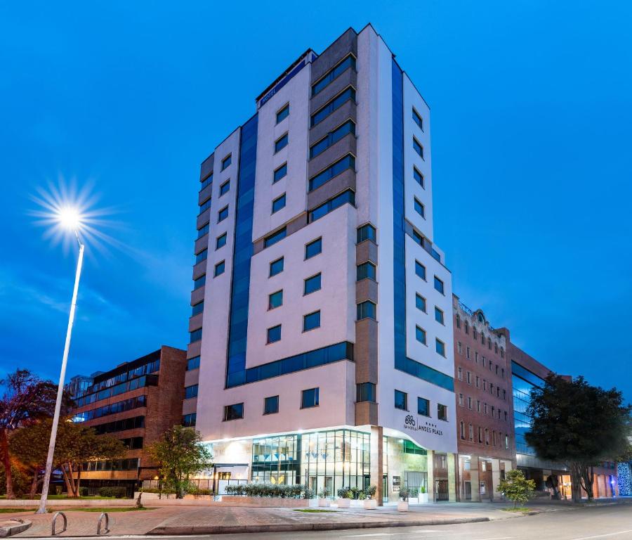 a tall white building on a city street at Hotel Andes Plaza in Bogotá