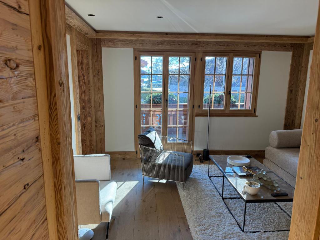 a living room with a couch and a table at Petite Fraise in Gstaad