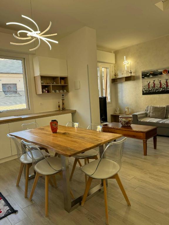 a dining room with a wooden table and chairs at A casa di Ada in Finale Ligure