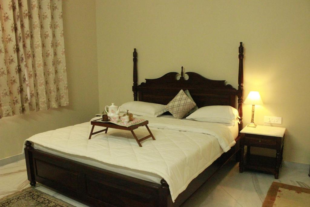a bedroom with a large bed with a table on it at Ratan Vilas in Jaipur