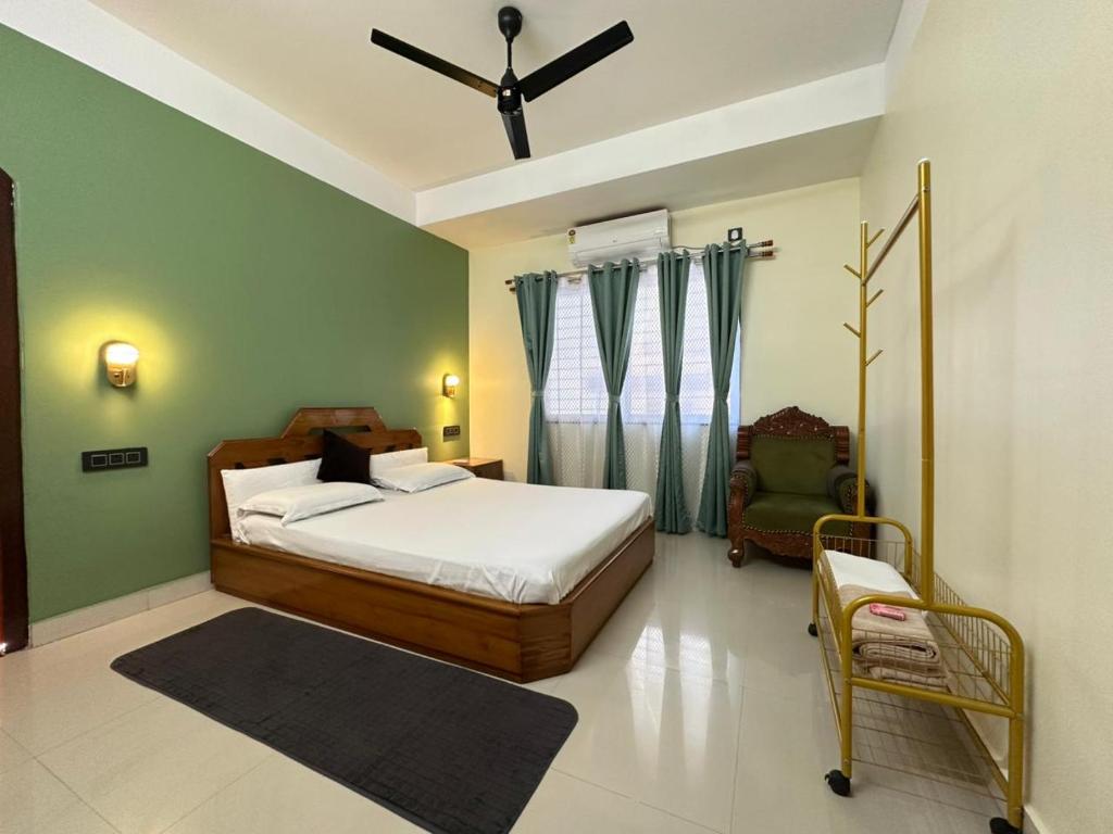 a bedroom with a bed and a chair in it at Zen Luxe Abode in Siliguri
