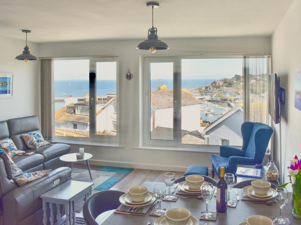 a living room with a view of the ocean at Seagulls View in Brixham