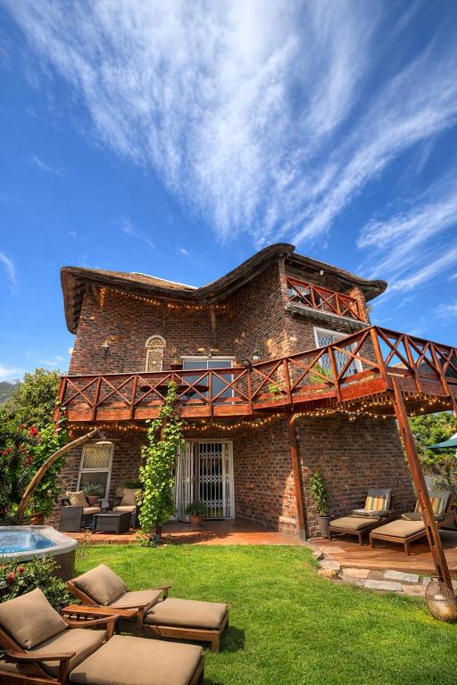 a large brick house with a patio and a pool at Hemel in Hermanus Three bedroom Home in Hermanus