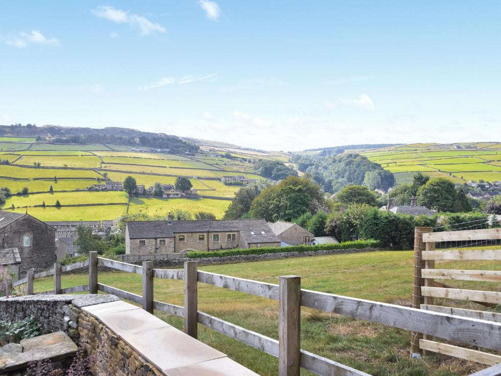 a view of a farm from a fence at Kestrel Cottage in Holmfirth