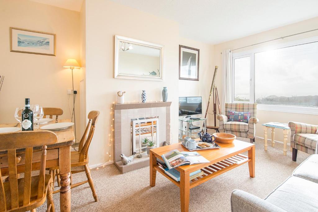 a living room with a table and a fireplace at Ty Peggie in Haverfordwest