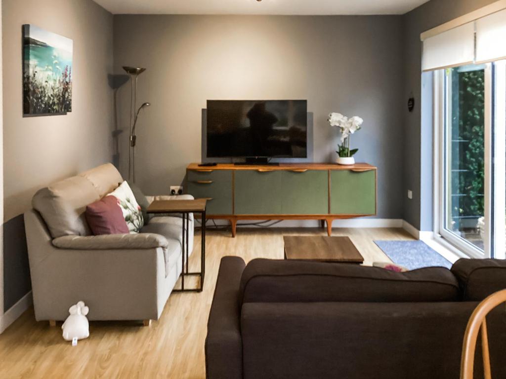 a living room with a couch and a tv at Uppermill Farm in Tarves