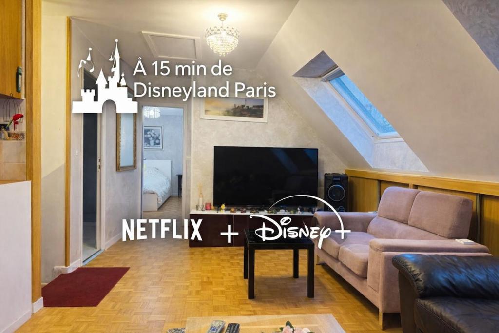 a living room with a couch and a tv at Close to Disney & Paris in Lagny