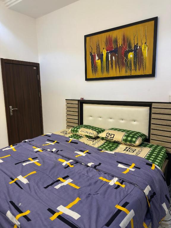 a bedroom with a bed with arrows on it at Tranquil in Lekki