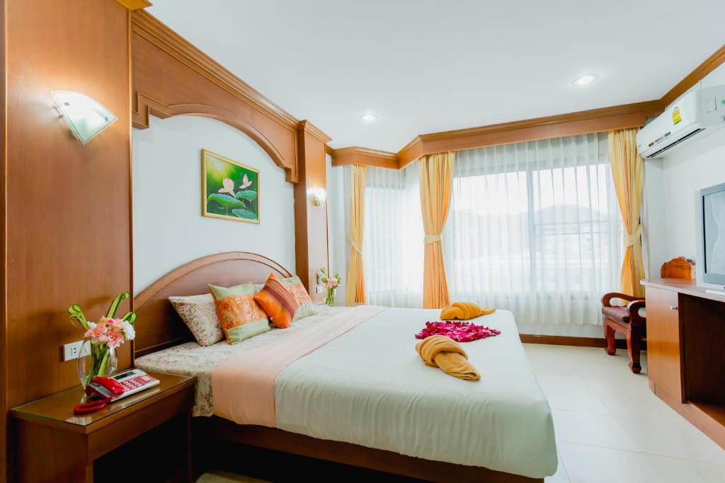 a bedroom with a large bed in a room at RK Guesthouse in Patong Beach