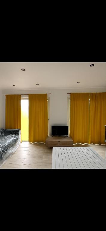 a room with a bed and a flat screen tv at Bungalow BAO in Fort-de-France