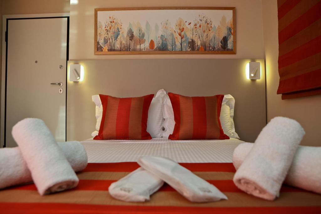 a bedroom with a bed with white towels on it at Best House Erato Neo Faliro Piraeus in Piraeus