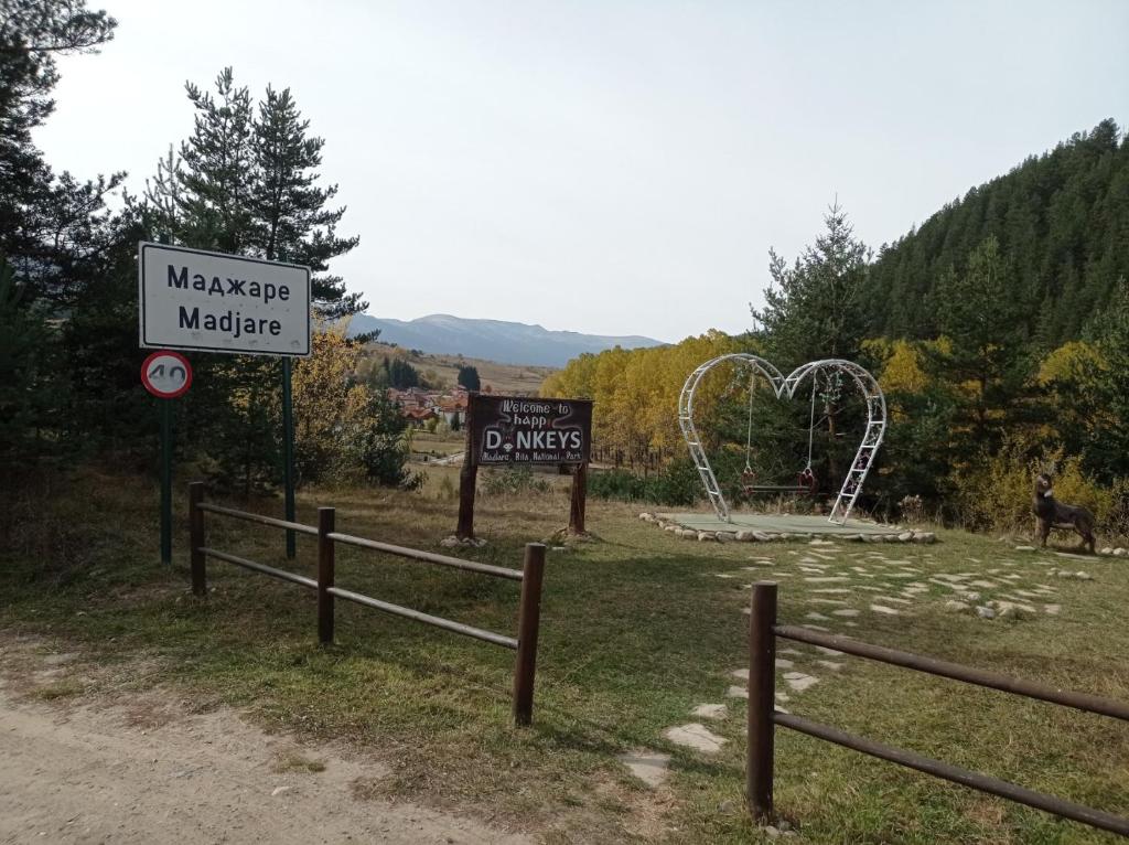 a sign for a park with a roller coaster at Guest House Марковата Къща in Madzhare
