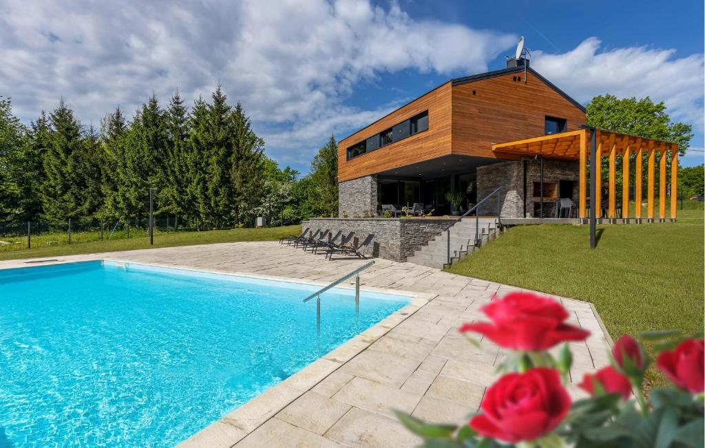 a house with a swimming pool in front of a building at Amazing Home In Slunj in Slunj