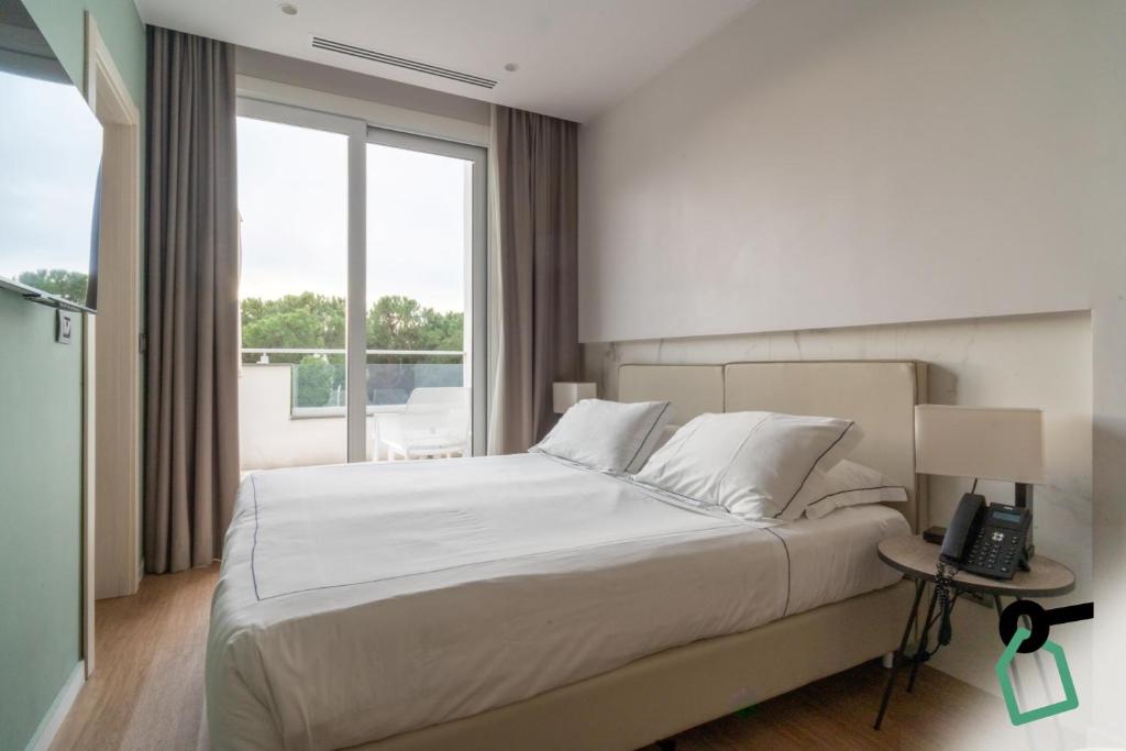 a bedroom with a bed and a phone on a table at Hotiday Lerici Porto in Lerici