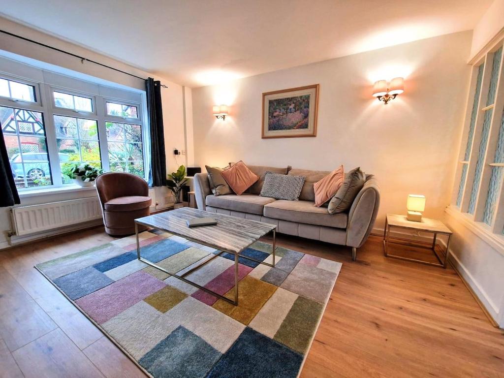 a living room with a couch and a coffee table at Central modern home with parking in Nantwich