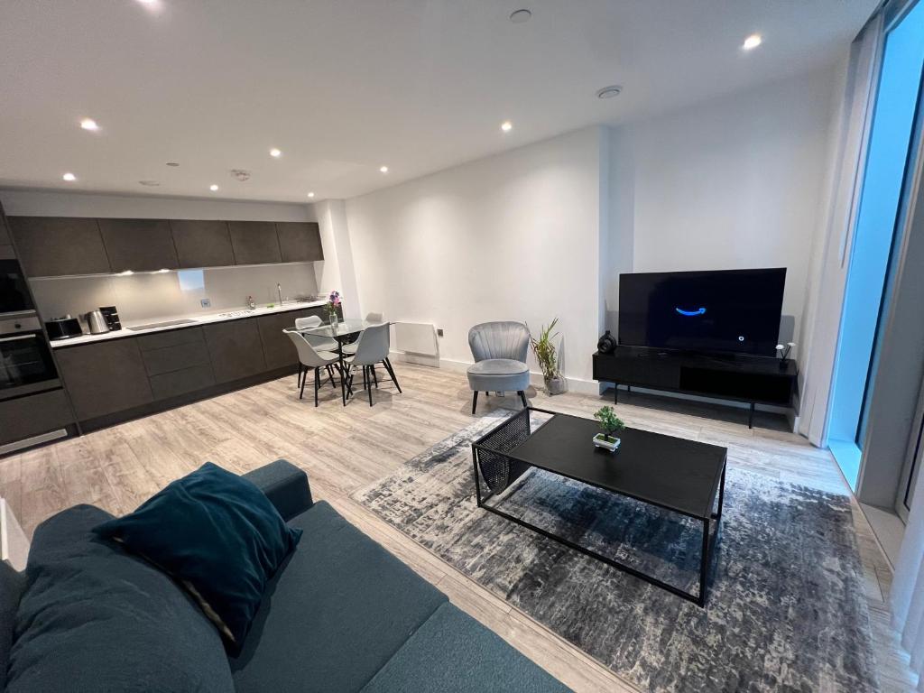 a living room with a couch and a table at Luxe Penthouse 2 bed Deansgate in Manchester