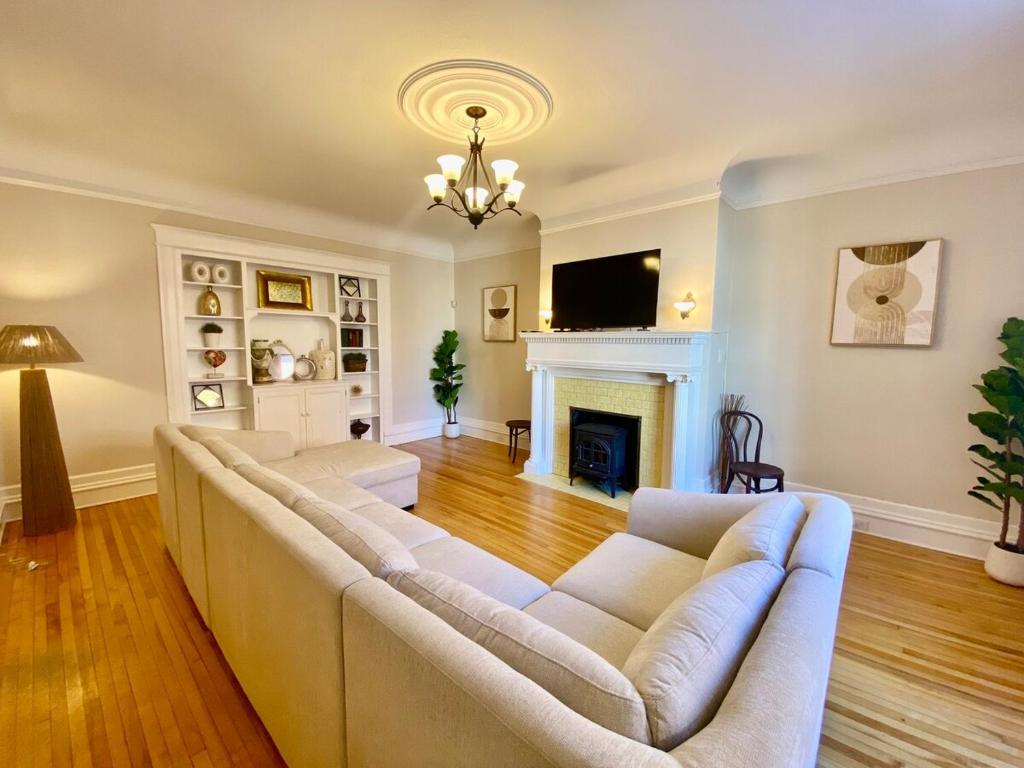 a living room with a couch and a fireplace at The Sealy Residence in Saint John