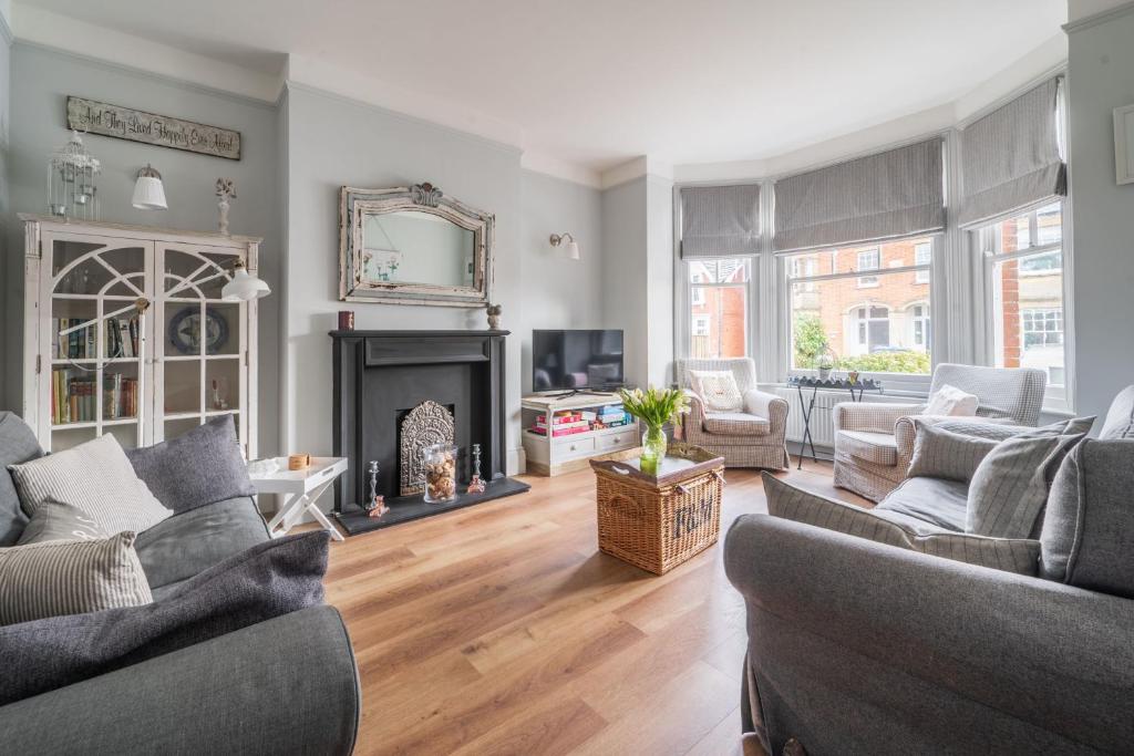 a living room with two couches and a fireplace at Danes House 4 in Aldeburgh