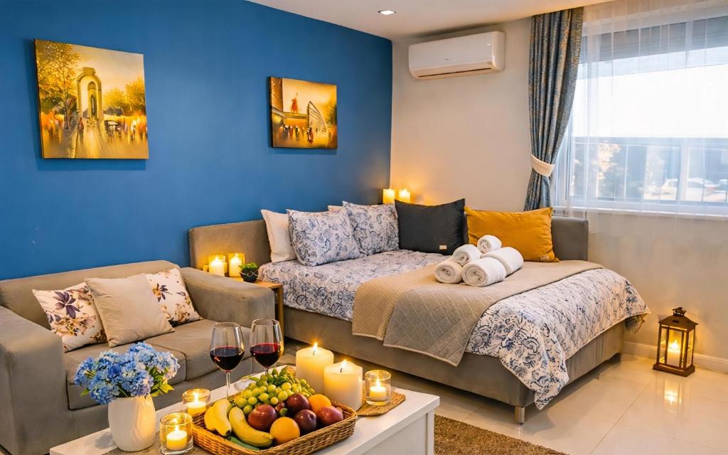 a living room with a couch and a table with fruit at N9 Studentski Loft - Cozy Apt with Private Parking in Sofia