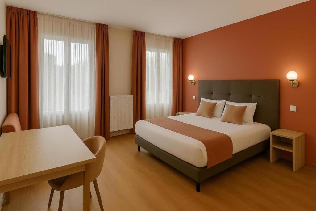 a hotel room with a bed and a desk at Thoiry Etoile Lodge, Sure Hotel Collection by Best Western in Thoiry
