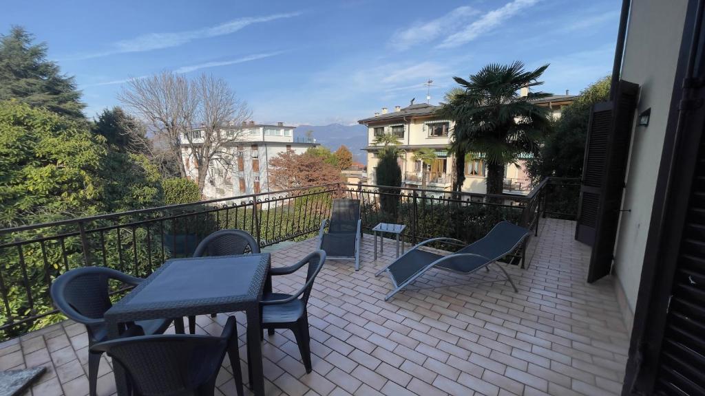 a balcony with a table and chairs and a building at Fior di Luna in Stresa
