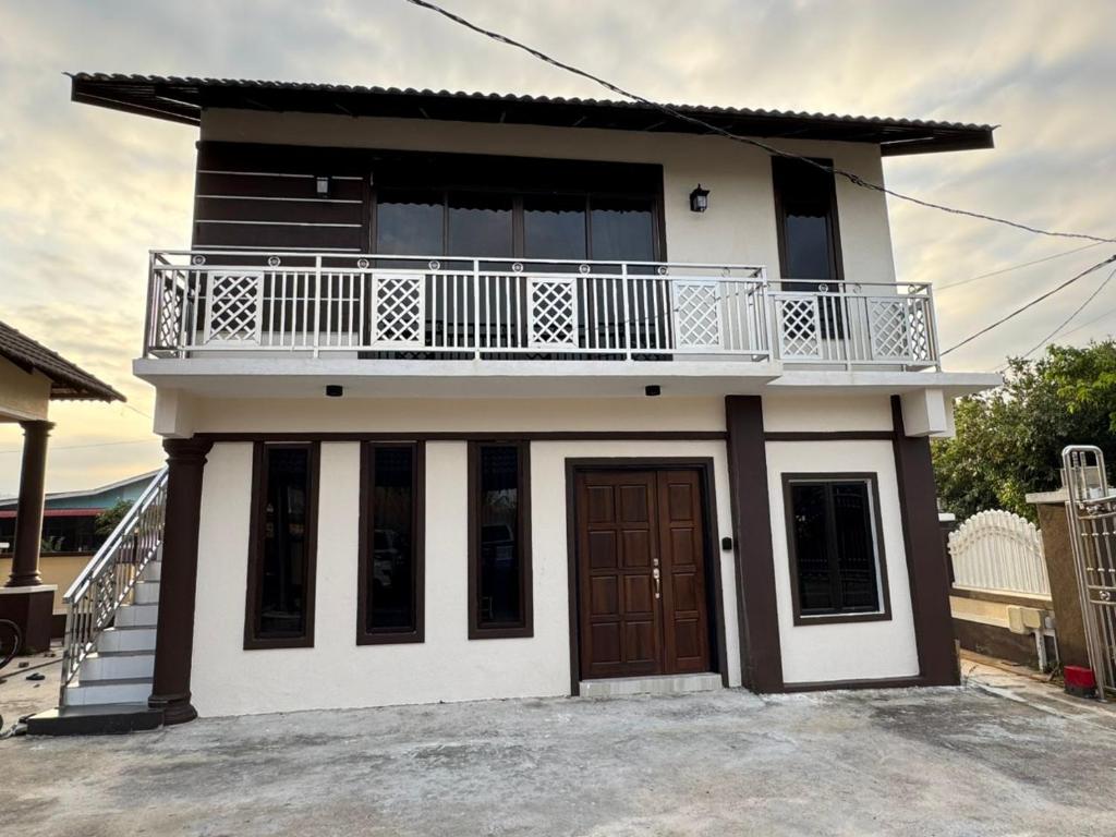 a small house with a balcony on top of it at GG Studio in Kampong Sura