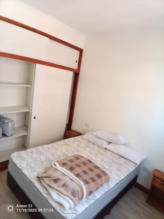 a bedroom with a bed with a wooden frame at Los corales torre norte in Santa Teresita